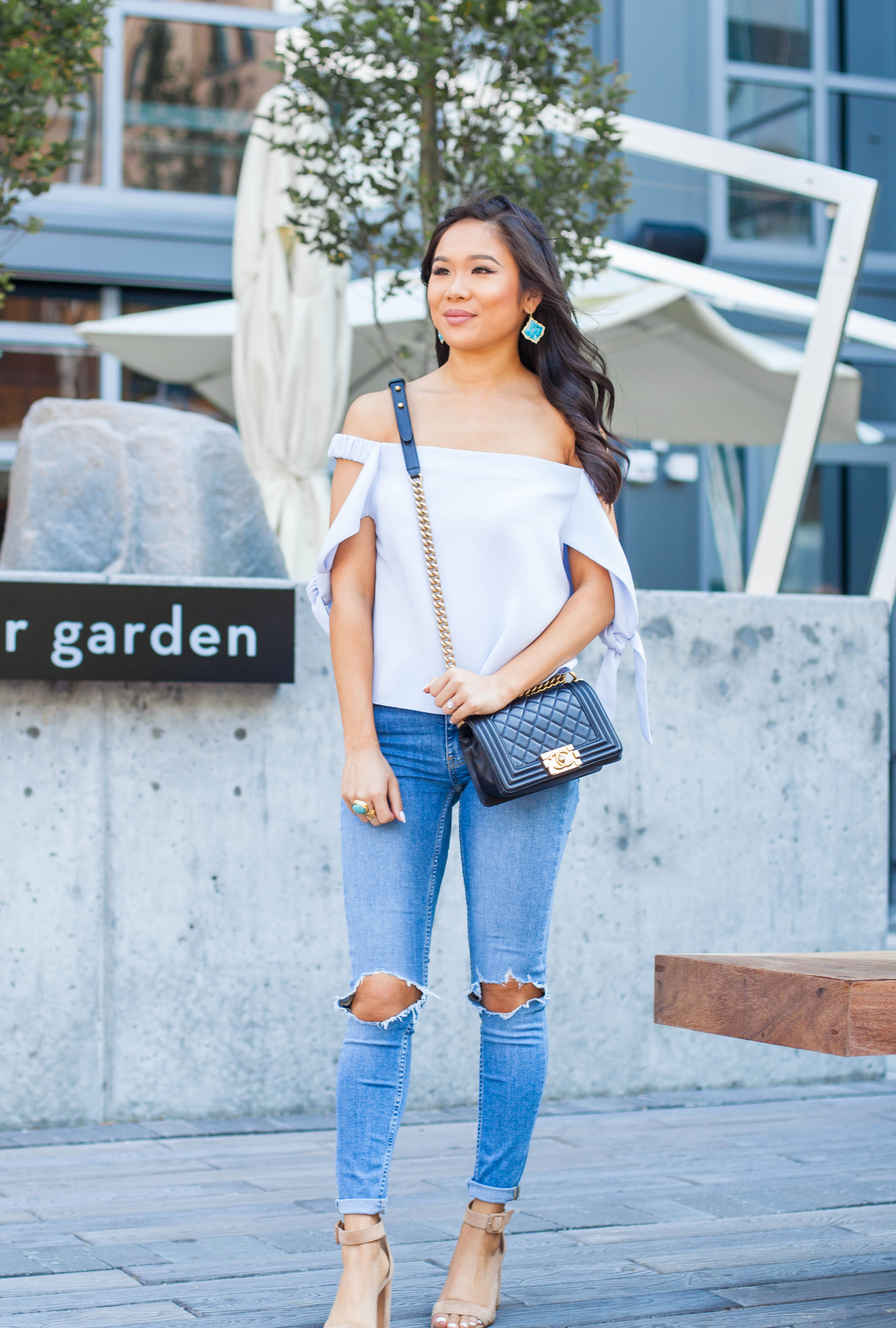 COLOR & CHIC | Off the shoulder top with tie sleeves, distressed jeans and Chanel boy bag