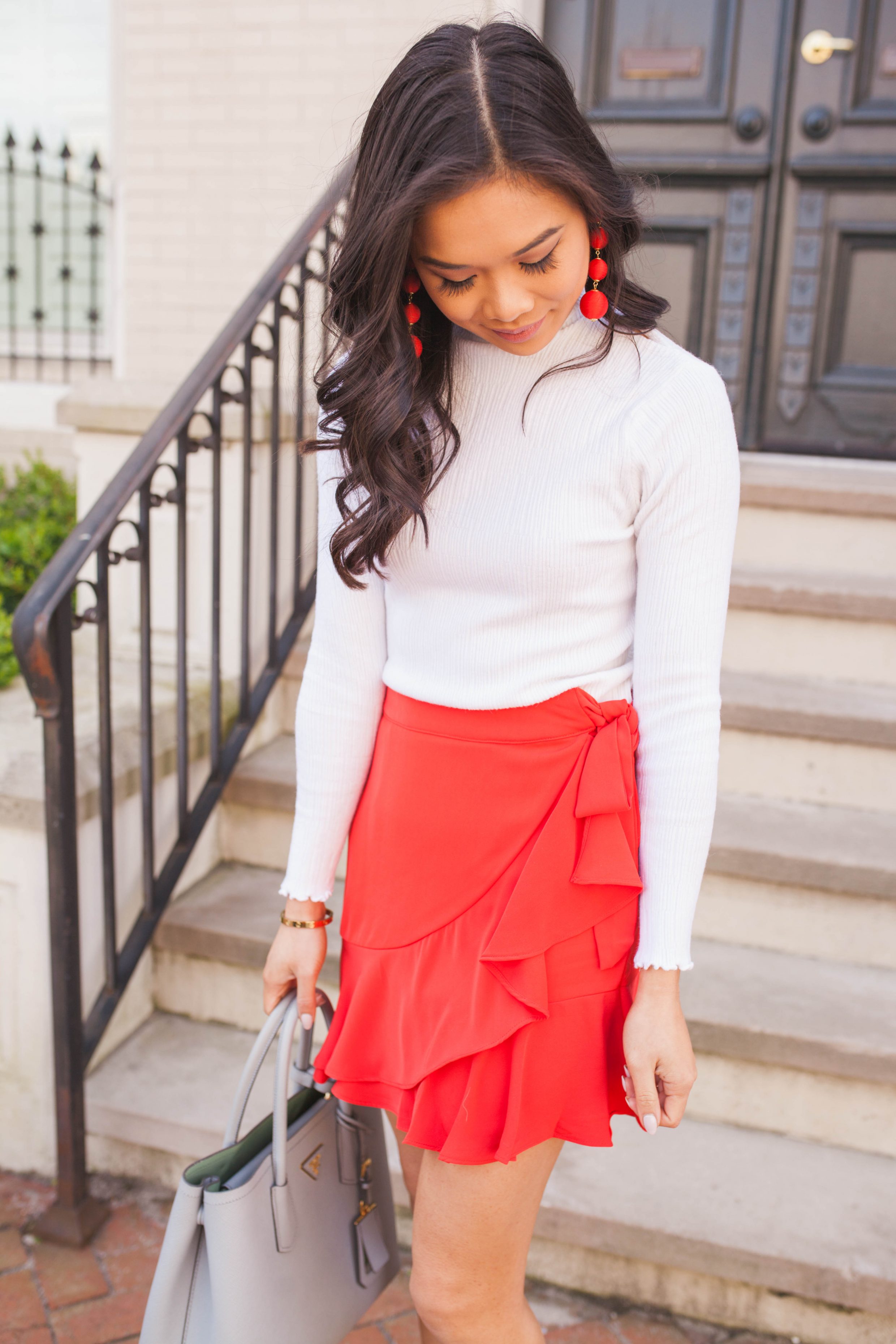 Red ruffle wrap skirt with wedges and ball drop earrings