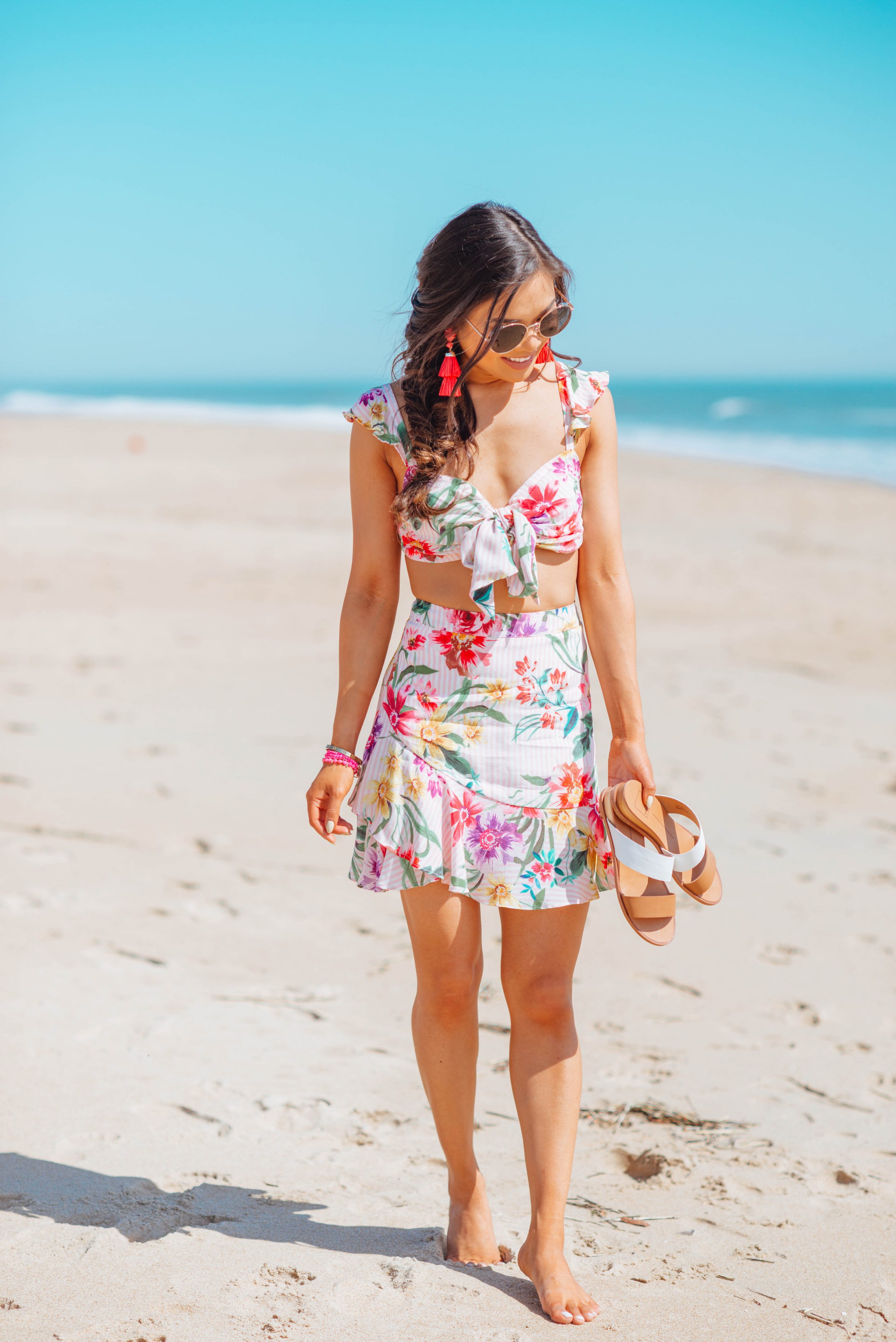 Blogger Hoang-Kim wears a floral two piece set with cognac sandals and a fishtail braid for the beach