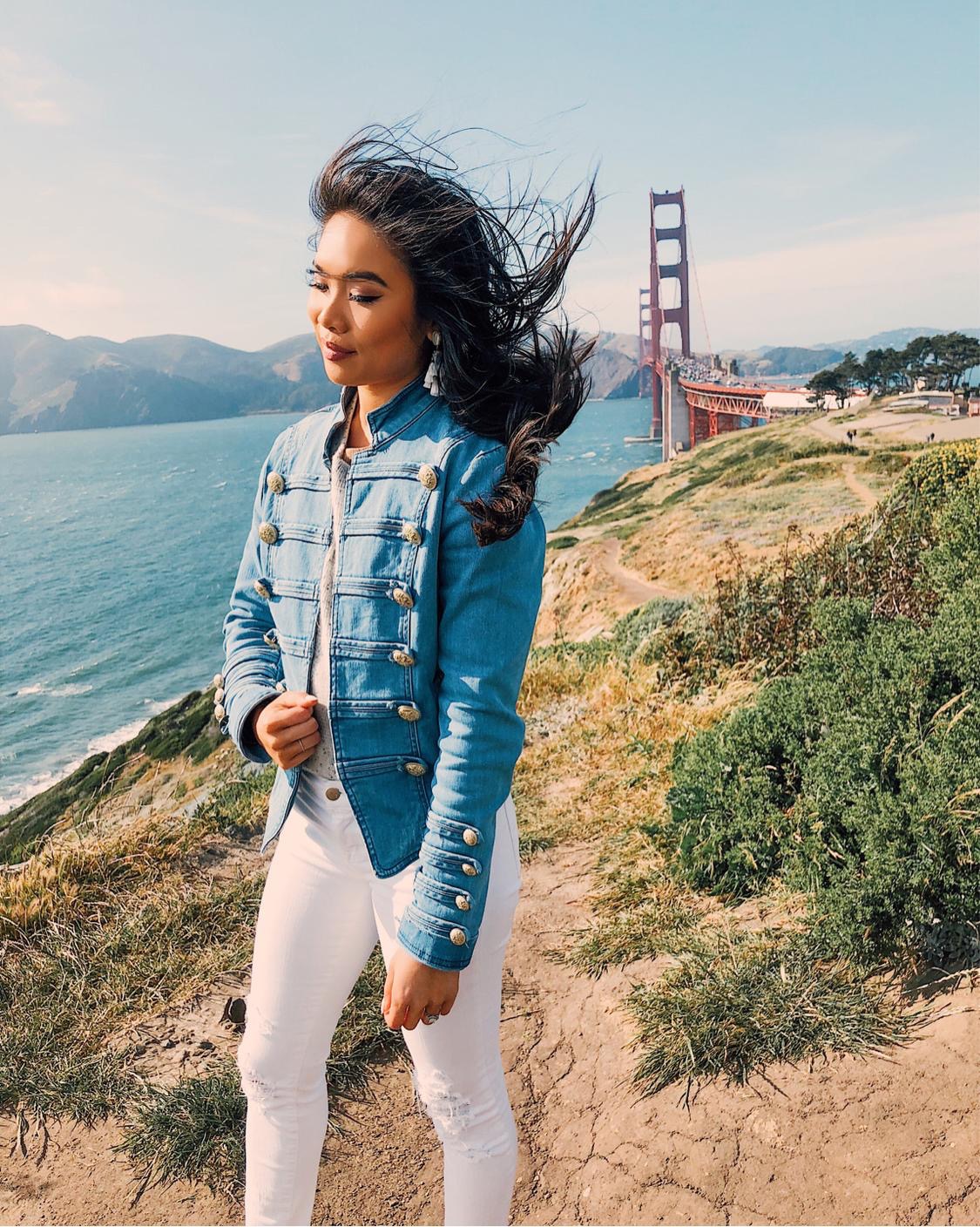 Best view of the Golden Gate Bridge wearing white jeans and a denim military jacket