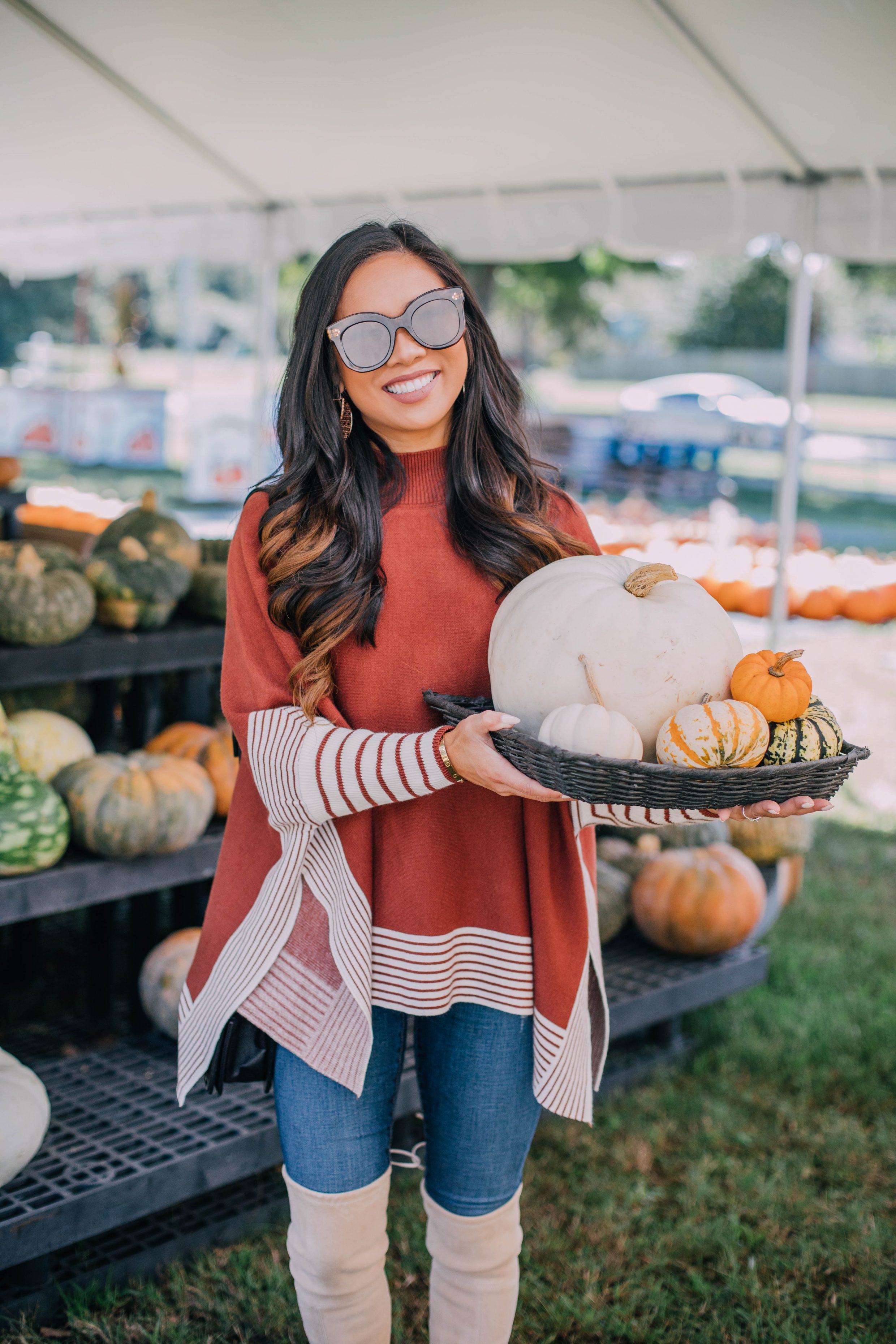 Blogger Hoang-Kim wears a cape sweater to visit Hunt Club Farm during fall