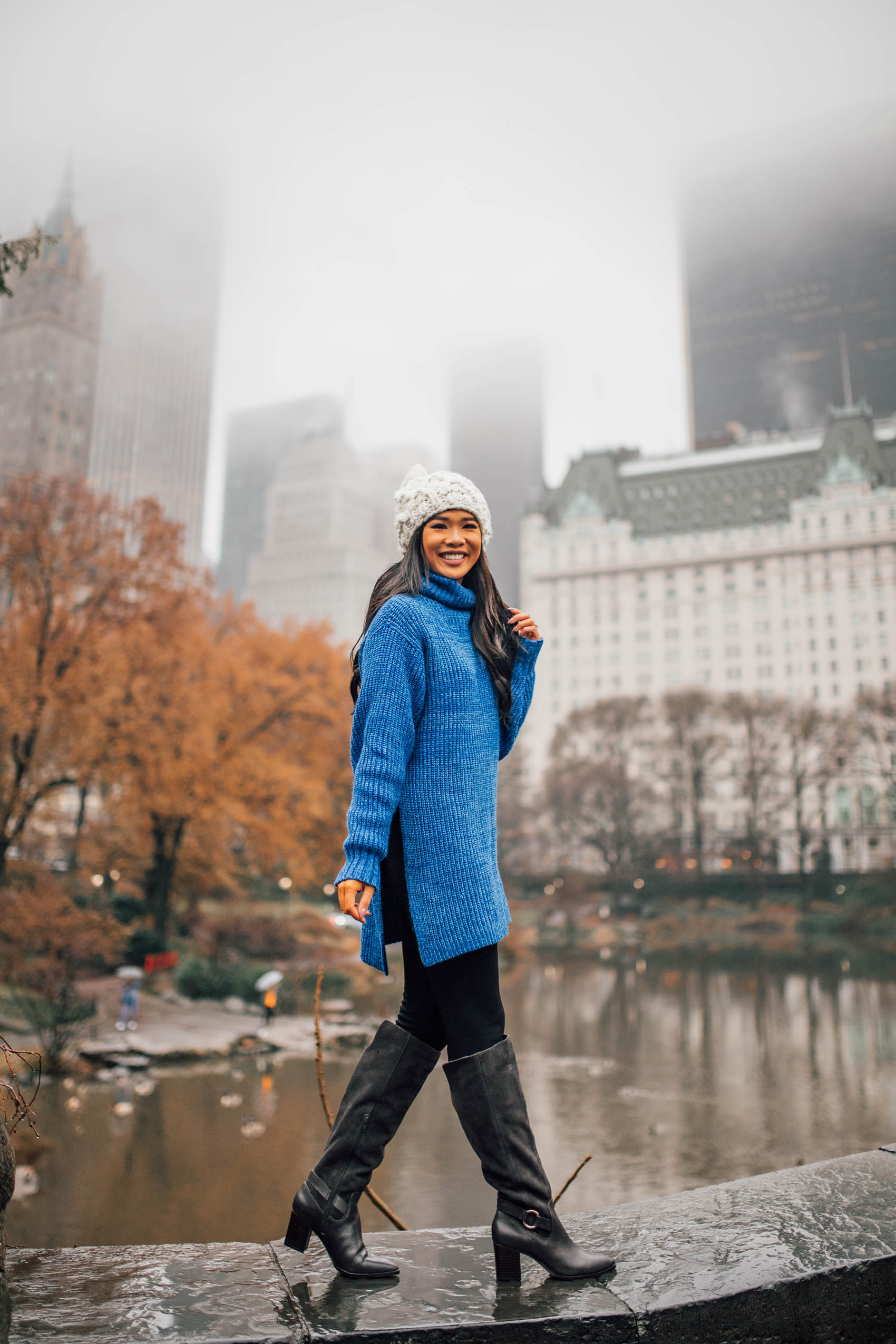 Blogger Hoang-Kim wearing a blue tunic sweater with Sole Society Daleena boots and chunky knit beanie