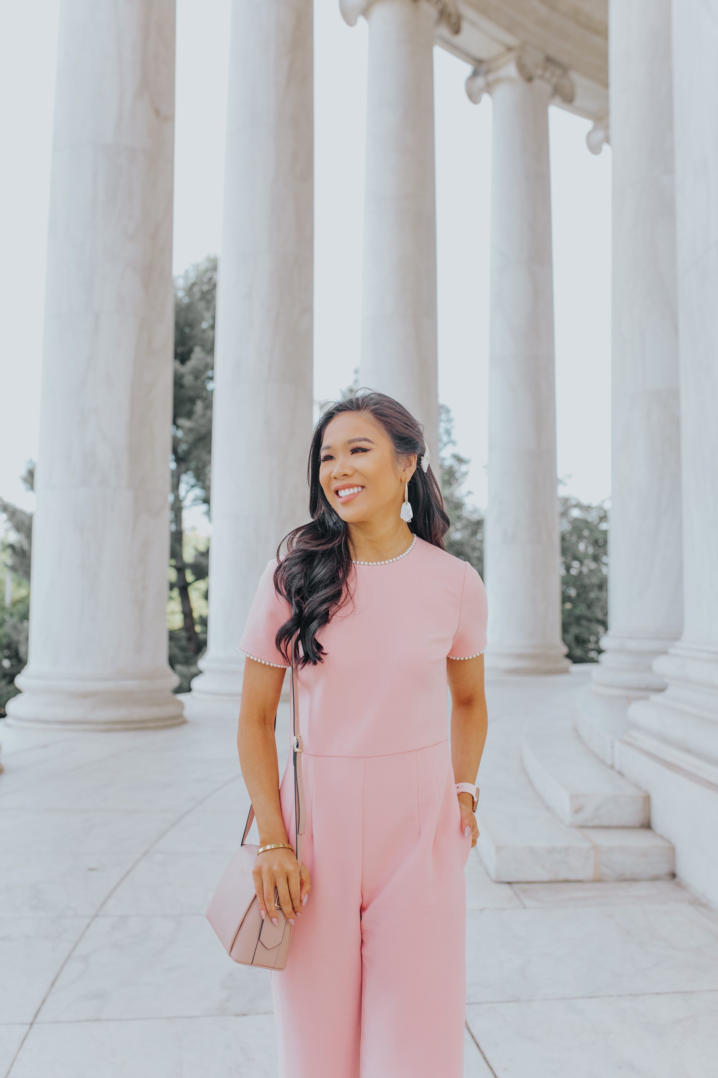 Blogger Hoang-Kim wears a pink pearl trim dressy jumpsuit perfect for weddings