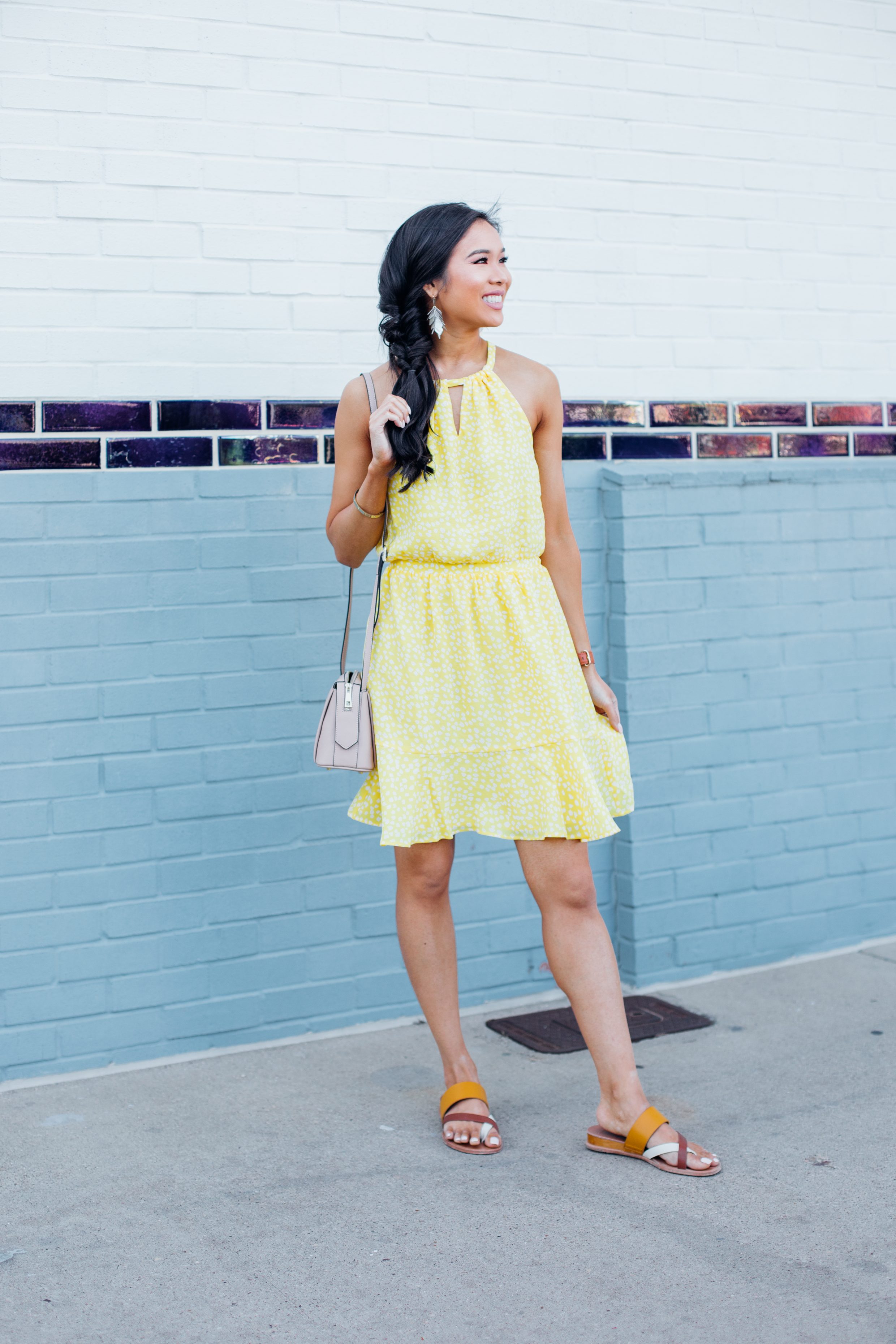 Asian woman wears a yellow casual dress with Dolce Vita sandals
