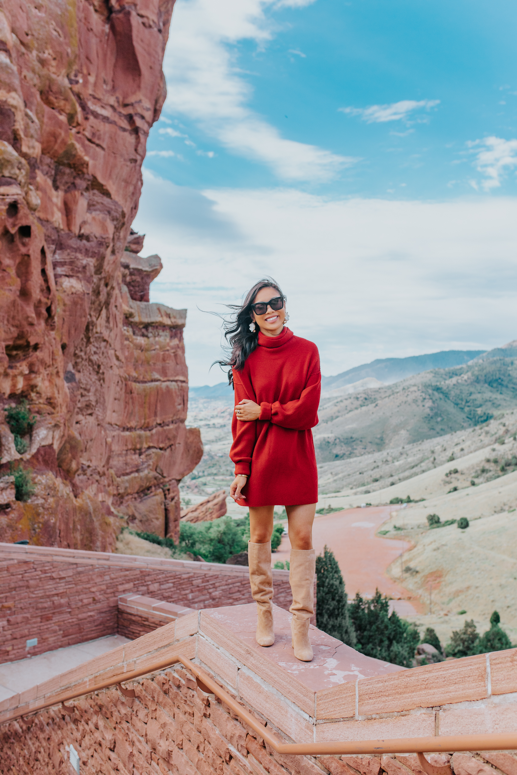 Blogger Hoang-Kim wears a free people slouchy tunic and knee high boots at Red Rocks Amphitheatre & Park in Denver