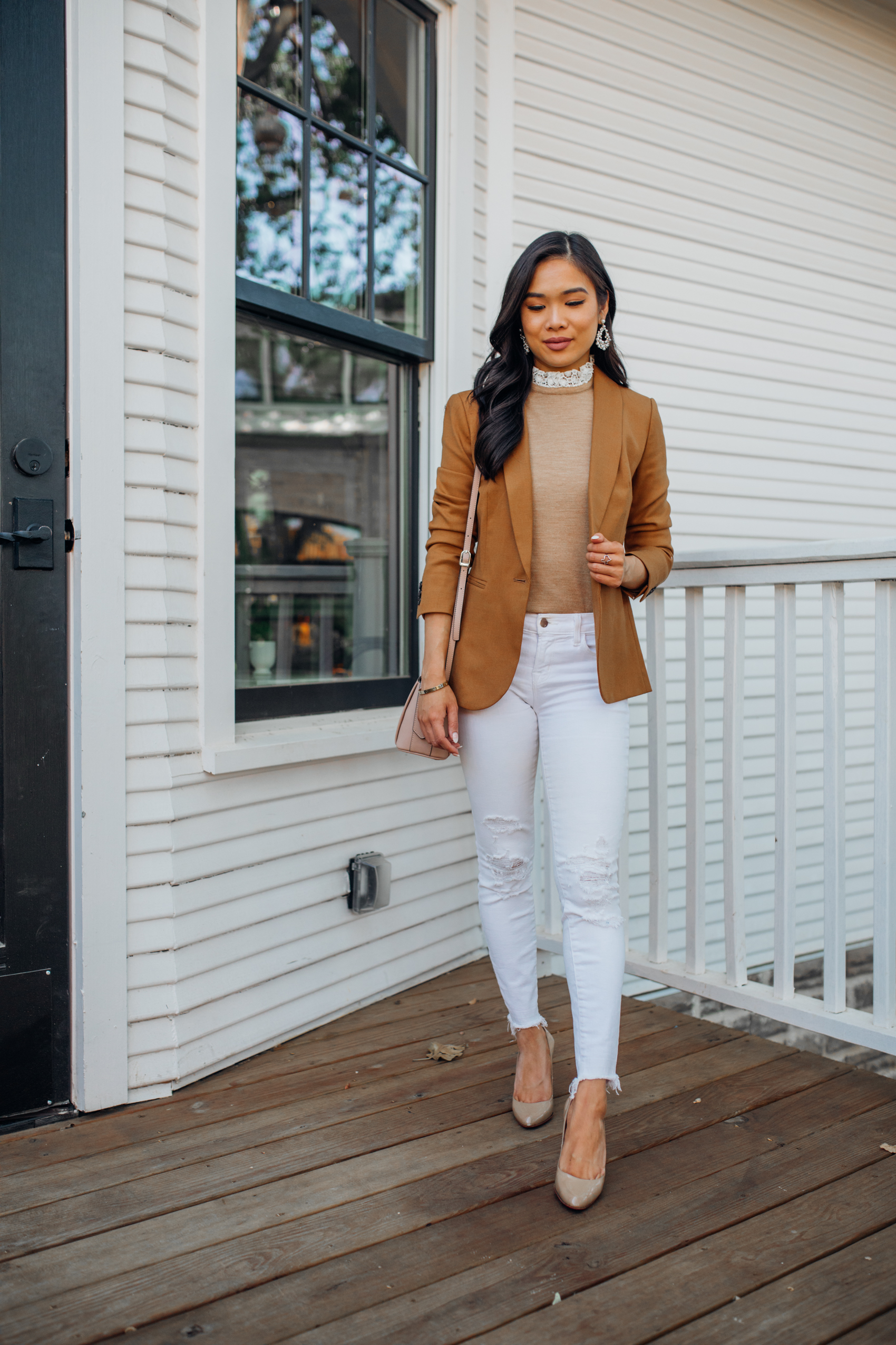 Petite blogger Hoang-Kim wears a brown blazer outfit for fall with JCrew Parke Blazer, Tippi sweater with lace collar detail, JBrand Distressed jeans and Christian Louboutin pumps in Bishop Arts Dallas