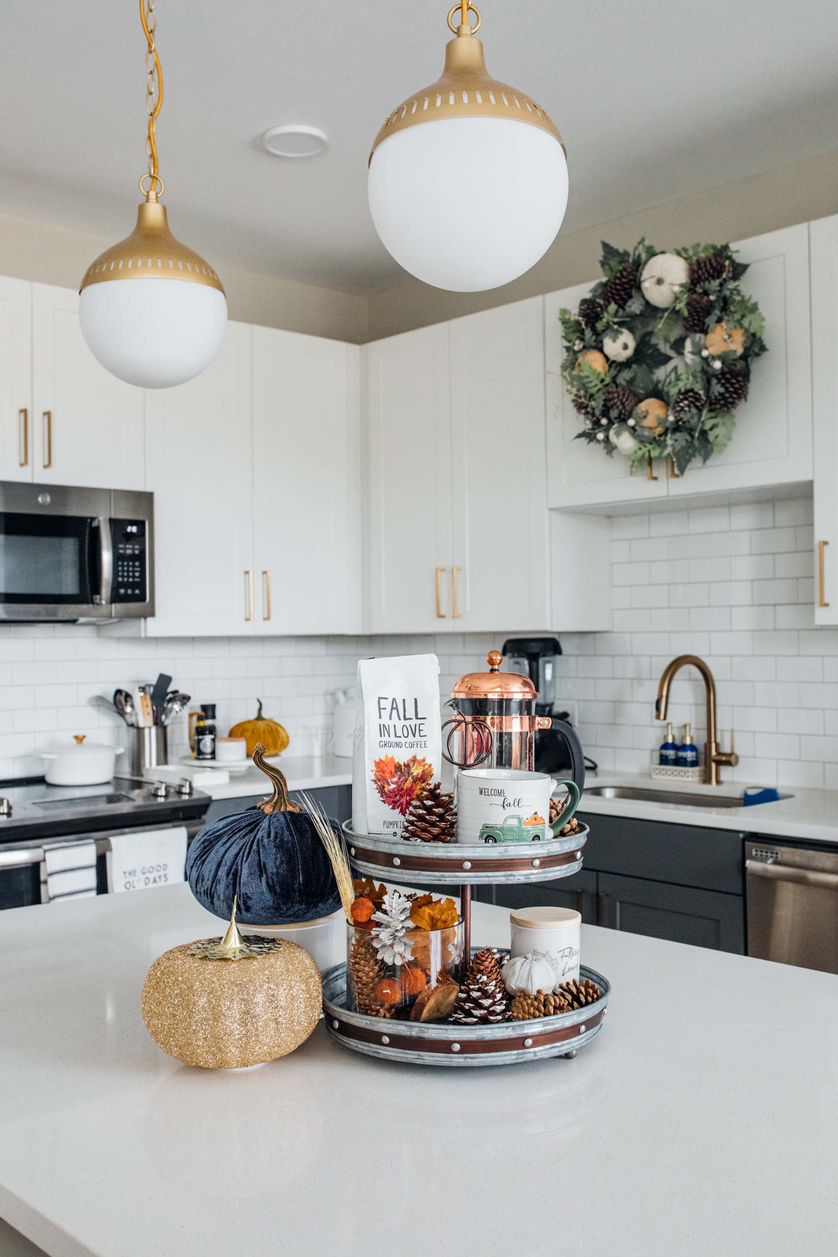 Fall kitchen decor in Dallas apartment with velvet pumpkins, pinecones and wreaths