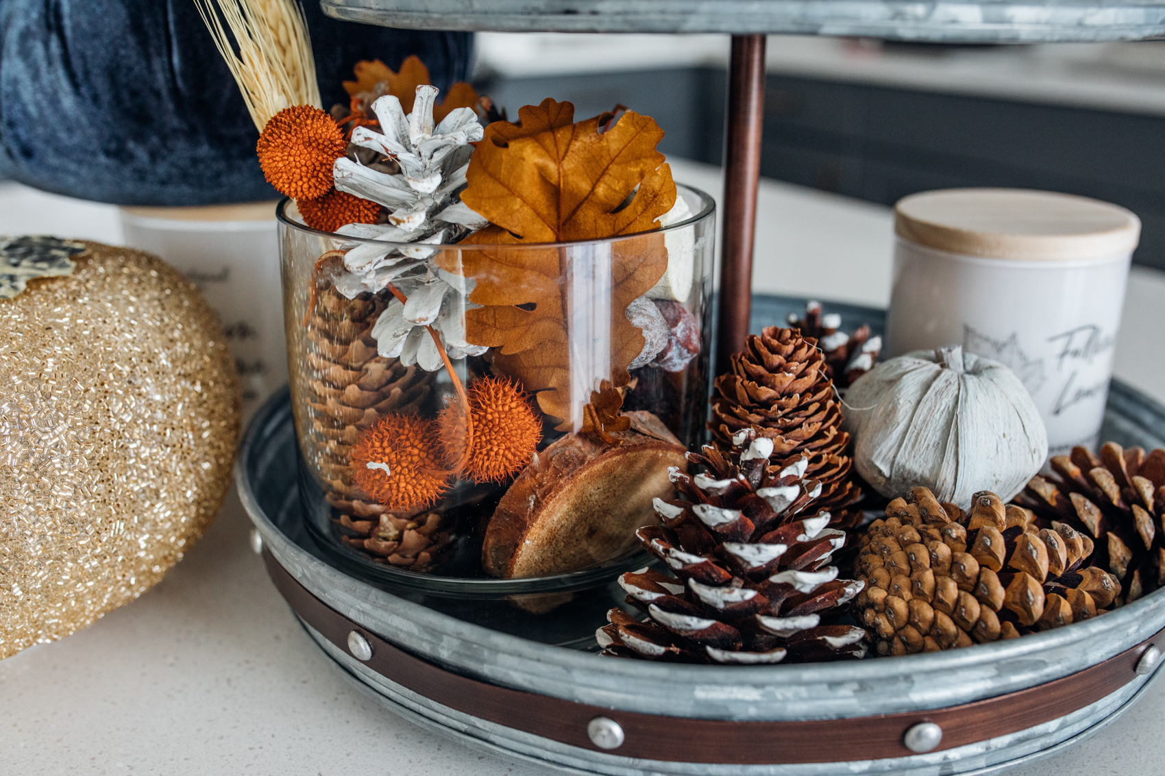 Fall kitchen decor with pinecones, fall leaves and candles from HomeGoods