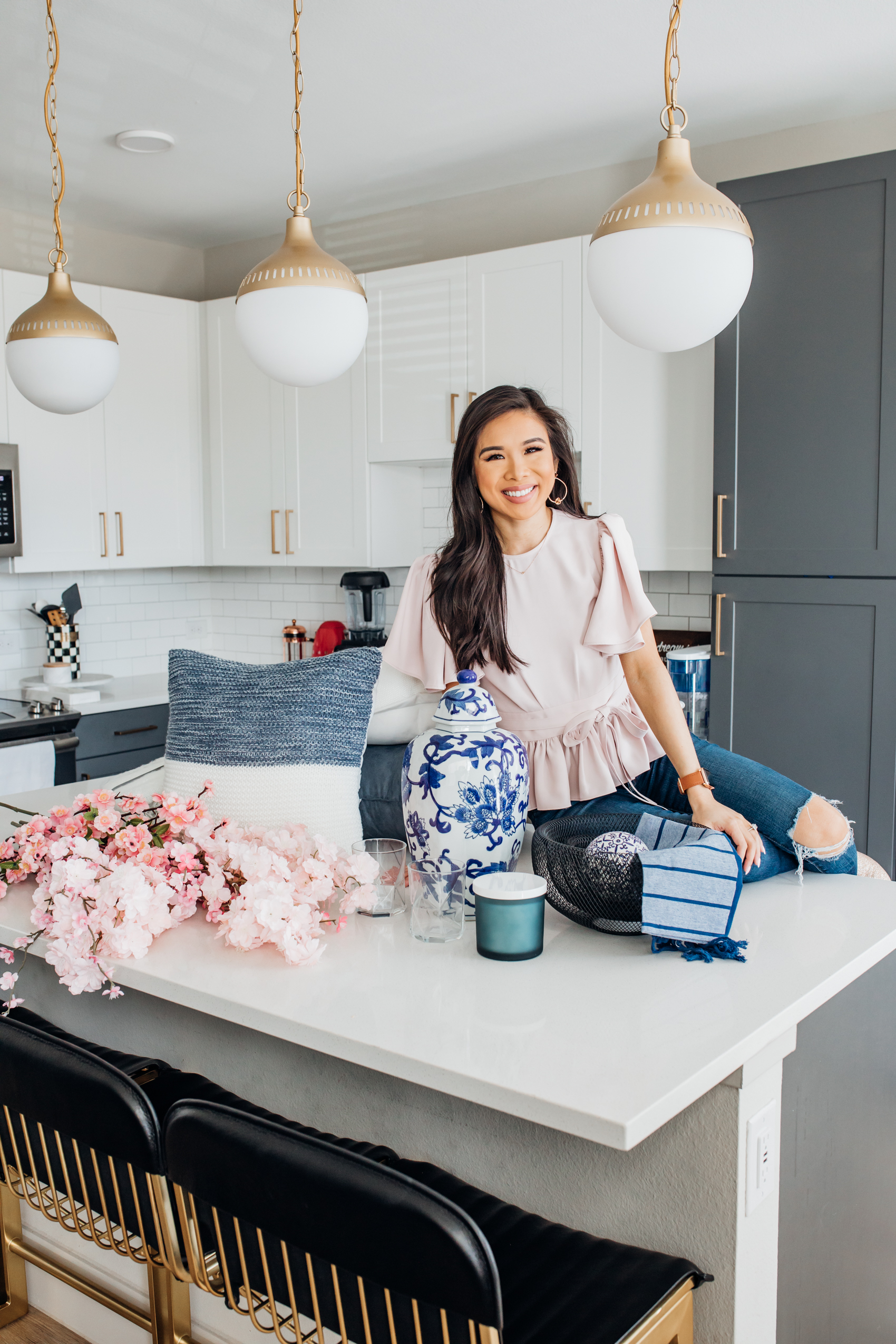 Blogger Hoang-Kim shares how she refreshes her kitchen with spring home decor using a ginger jar, cherry blossoms and candles