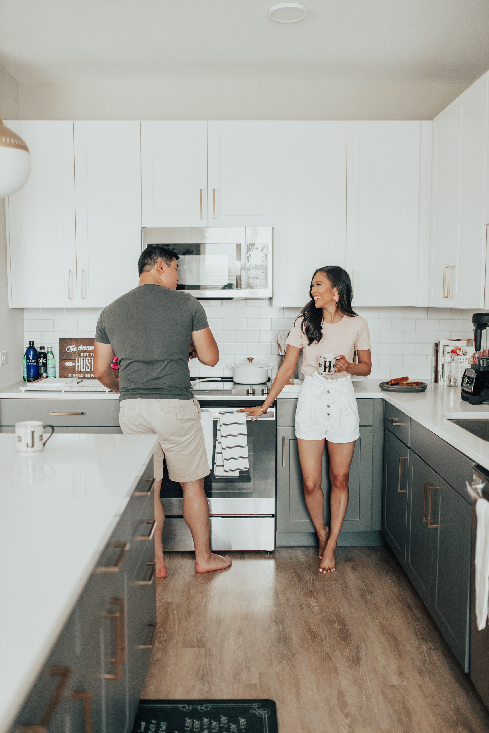 Blogger Hoang-Kim and her fiance Jonathan in their Dallas luxury apartment with two tone cabinets and gold hardware