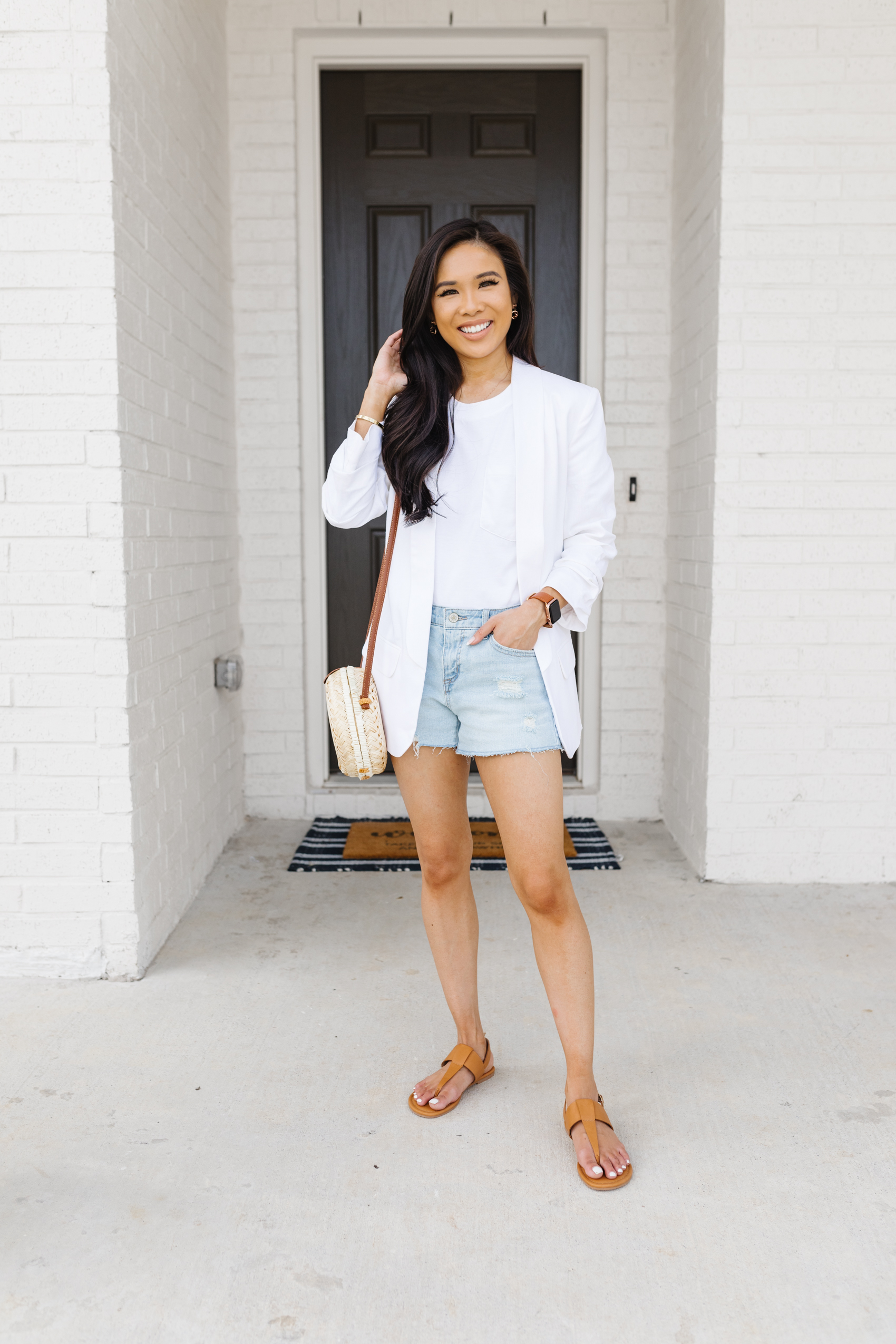 Blogger Hoang-Kim wears a Summer outfit with a white tee, linen ruched sleeve blazer and distressed denim shorts from Walmart