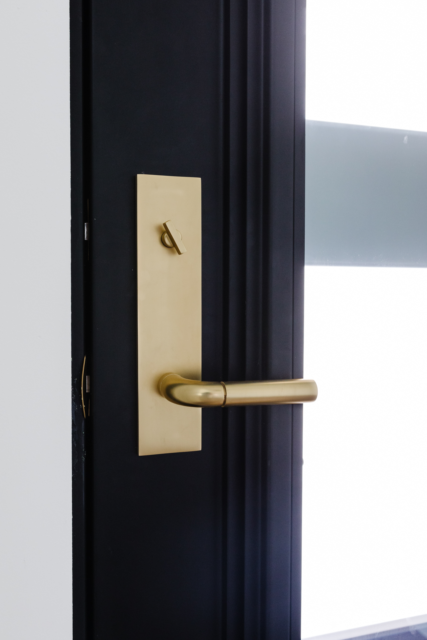 Aged brass Tumalo lock from Rejuvenation on an iron front door