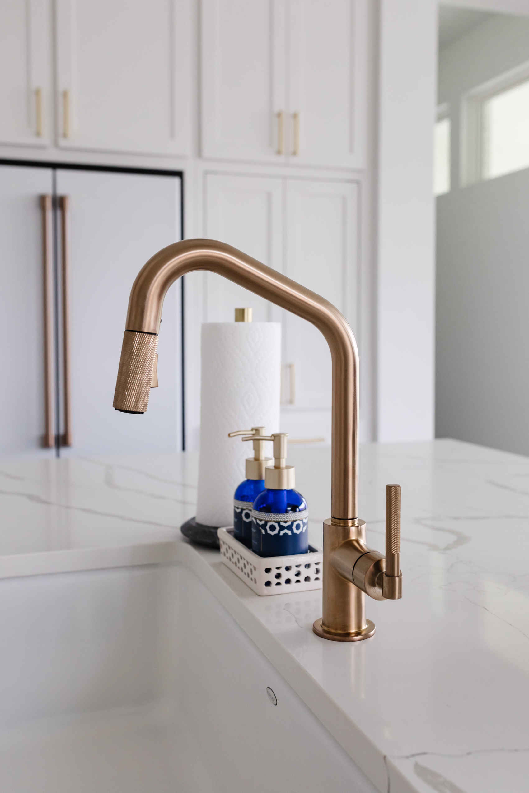 Brizo Litze Angled Pull Down faucet with knurled handle, Kohler Whitehaven farmhouse sink in a transitional kitchen