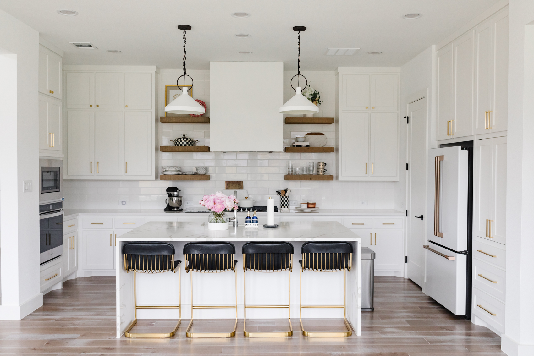 Black and white transitional kitchen in a one-story home in Dallas with McGee & Co Limoges pendants, Cafe Appliances Refrigerator, CB2 Rake Barstools and more