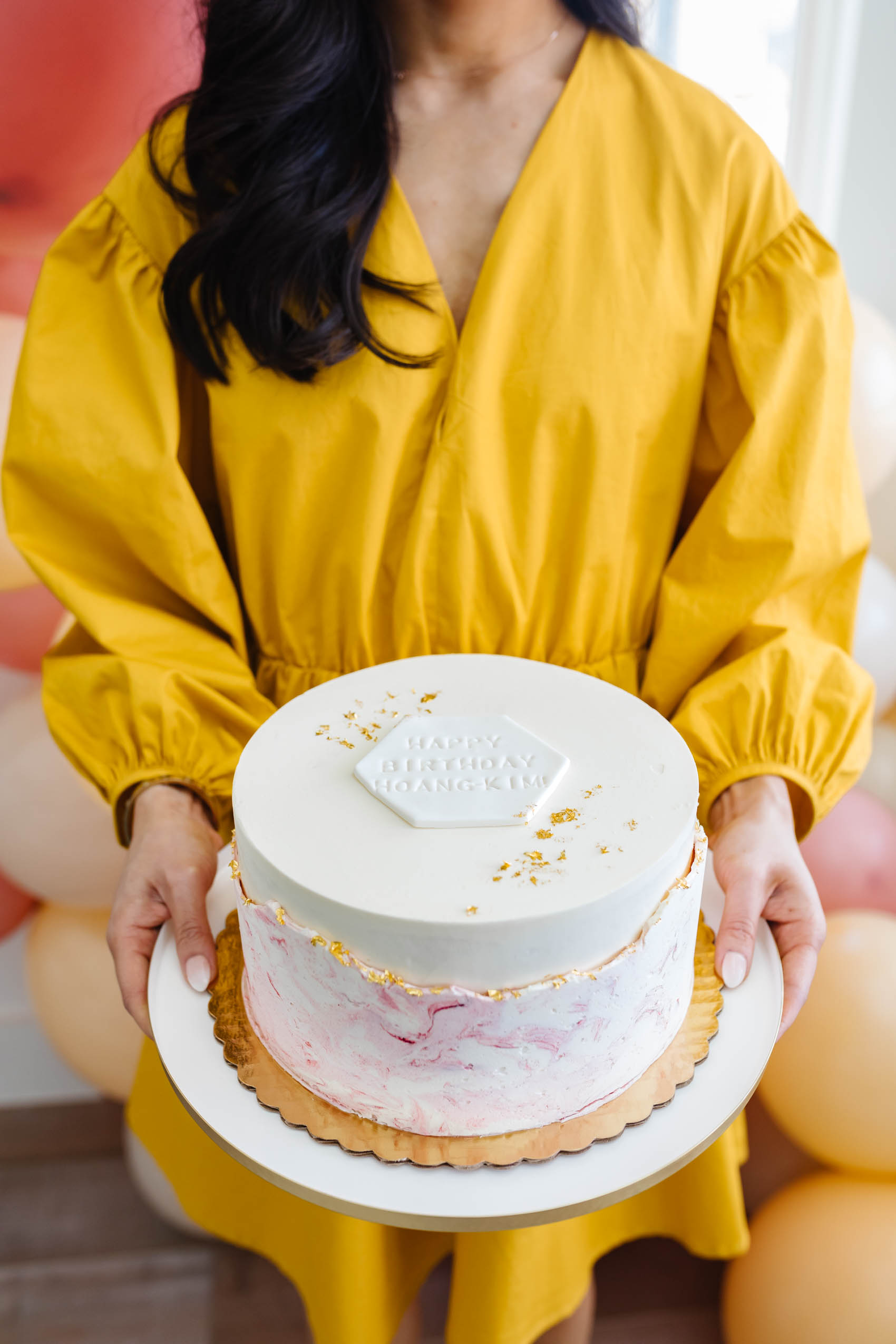 Hoang-Kim holds her 30th Birthday Cake from DFW Baker Crumb & Kettle. This is the vanilla cake with hazelnut buttercream with marble finish.