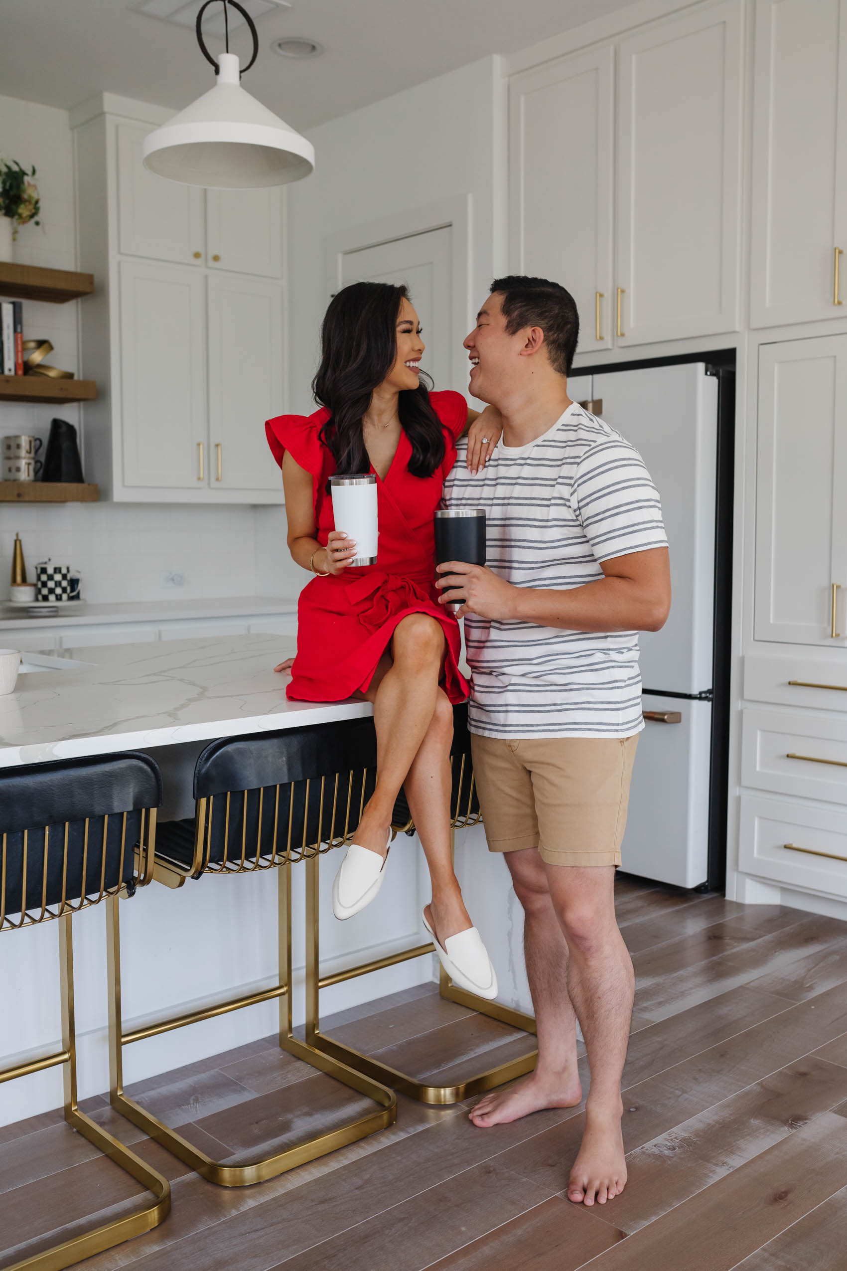 Blogger Hoang-Kim and her fiance Johnny wearing Madewell in their white kitchen of their transitional style house.