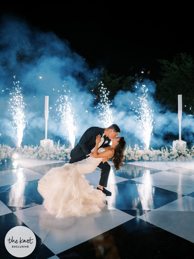 Hoang-Kim Cung and her husband Jonathan Van on a checkerboard dance floor with cold sparks at their wedding wearing Vera Wang Gemma bridal gown and bespoke Thai Nguyen Atelier tuxedo