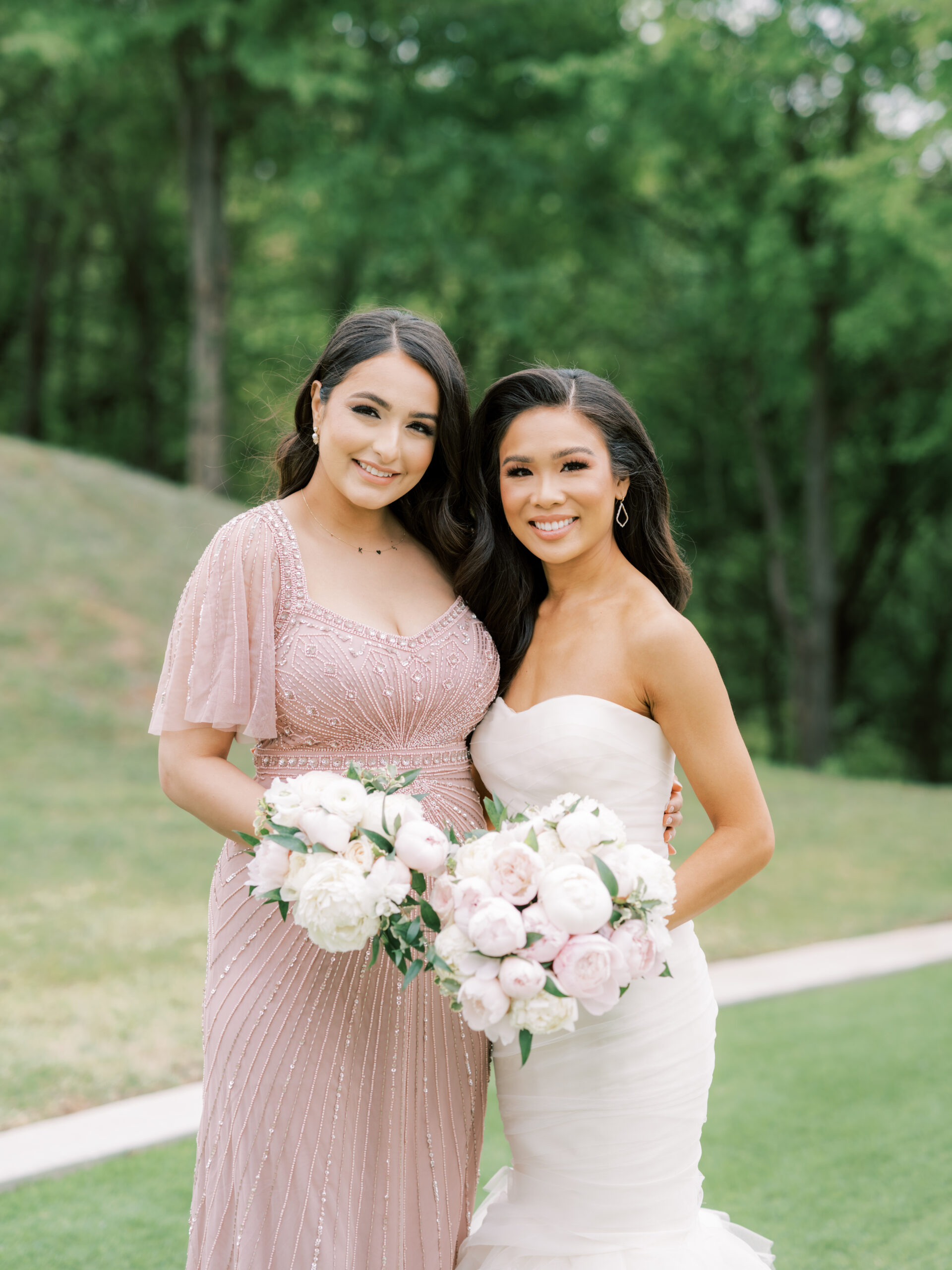Hoang-Kim wearing a Vera Wang Gemma mermaid gown with her bridesmaid wearing an Adriana Papell hand-beaded flutter sleeve blush pink gown