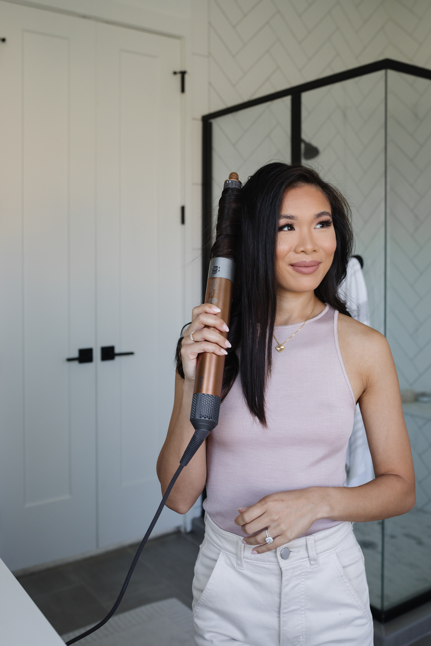 Blogger Hoang-Kim using the new Dyson Air Wrap with barrels that go in both directions.